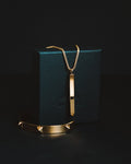 Gold-coloured pendant necklace on display, natural stone pendant reference — placeholder image