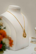 Gold necklace and earring set displayed on a mannequin, hoop earring reference — placeholder image